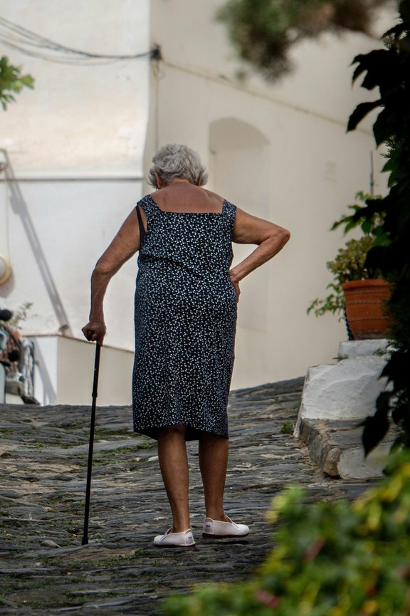 Old Woman Walking With Cane