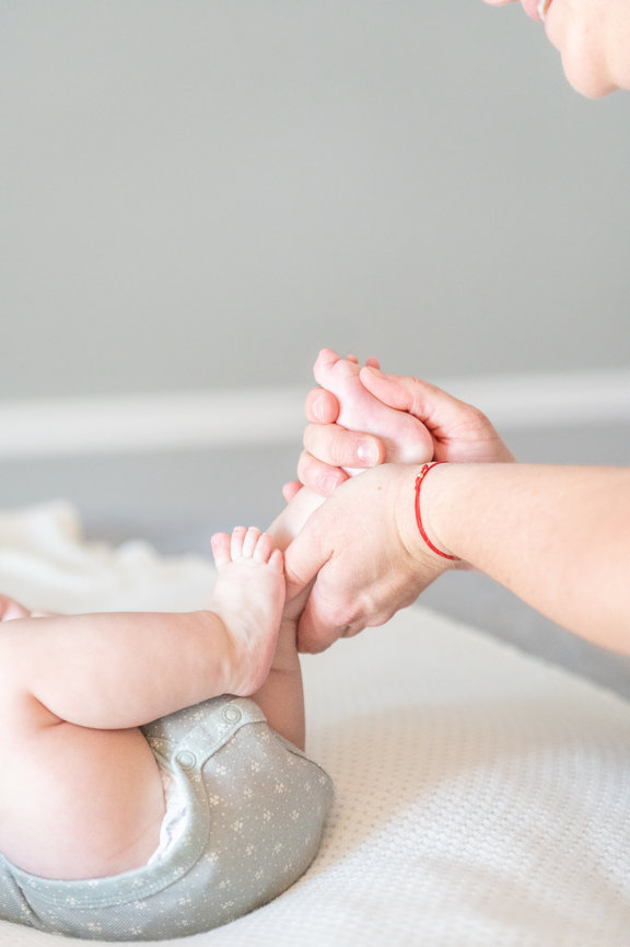 Deandra holding a baby's foot